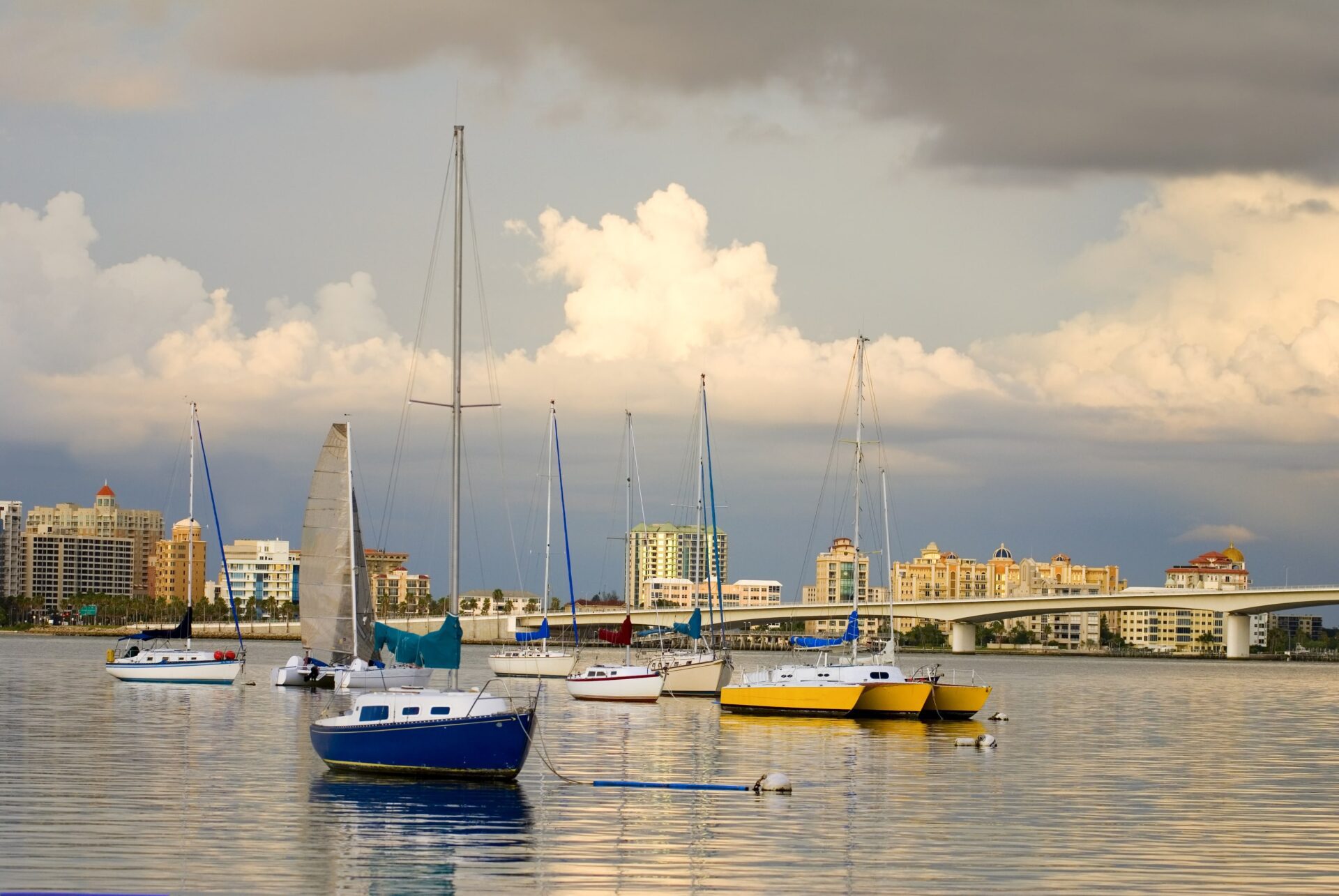 Boats in a harbor under a cloudy sky